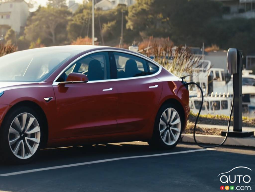 A Tesla Model 3 at a charging station